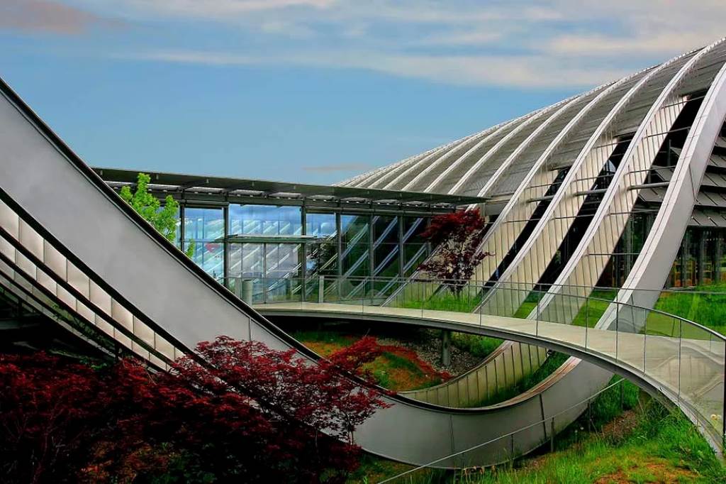 Architect reviewing AI-optimized bridge model on a computer screen.