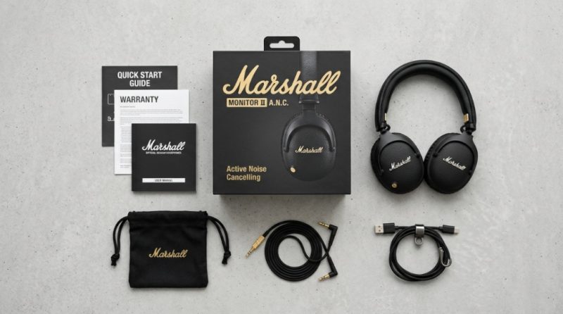 Marshall headphones resting on a wooden table next to a vinyl record player.